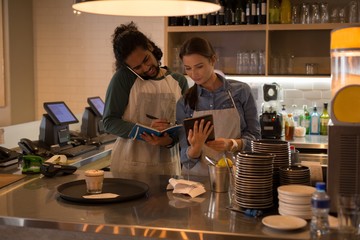 Waiters working at coffee counter