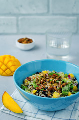 Mango black bean arugula pumpkin seed quinoa salad