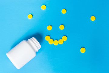 Colorful pills on the blue background.