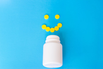 Colorful pills on the blue background.