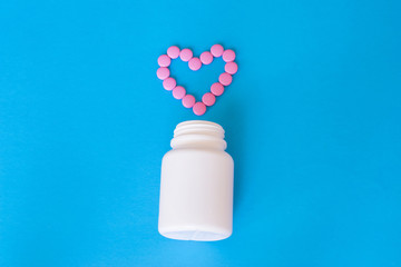 Colorful pills on the blue background.