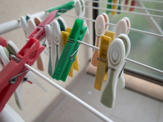 clothes pegs on a white line dryer