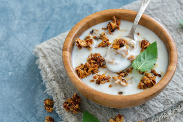 Natural yogurt with oat flakes and nuts in honey.