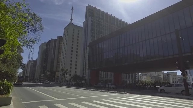 SAO PAULO, SP - BRAZIL JULY 2017 - Slow camera of people walk on the sidewalk of the Paulista avenue on a sunny day
