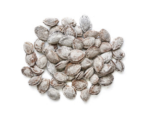 Salted apricot seeds isolated on white background. Apricot bones fried with salt in ashes. Top view.