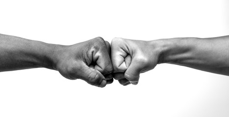 Man giving fist bump, monochrome, black and white image. - obrazy, fototapety, plakaty