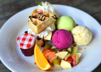 Ice cream mix fruit setting in white plate ready to eat.