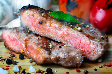 Medium rare beef steak grill in charcoal flamimg