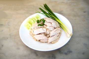 Boiled chicken, fillet on a plate with a slice of cucumber to eat a meal with rice and sauce, Fast Food commonly eaten in the countries of Thailand