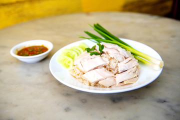 Boiled chicken, fillet on a plate with a slice of cucumber to eat a meal with rice and sauce, Fast Food commonly eaten in the countries of Thailand