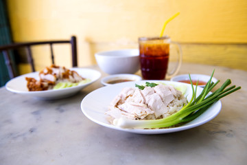 Boiled chicken, fillet on a plate with a slice of cucumber to eat a meal with rice and sauce, Fast Food commonly eaten in the countries of Thailand