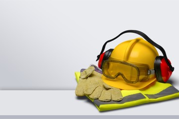 Safety helmet with earphones and goggles on construction