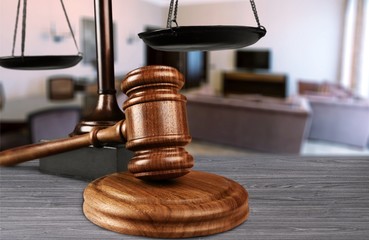 Justice Scales and books and wooden gavel on table. Justice