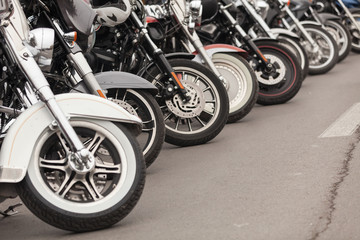 Row of motorcycles parked on a street - Powered by Adobe