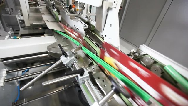 Production factory conveyor belt transports cardboard boxes for food industry.Factory manufacturing line.