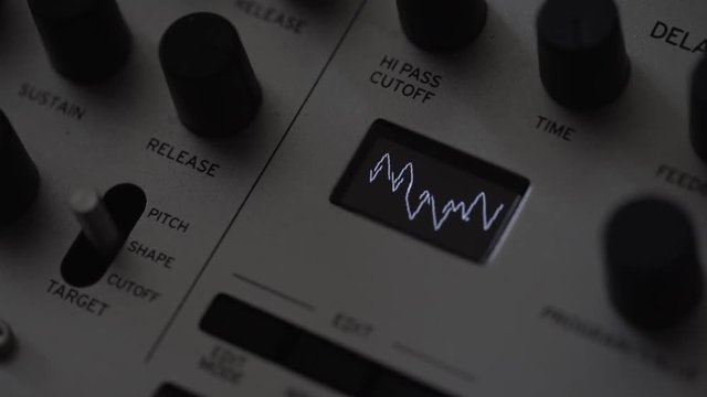 Music composer creating waveform on synthesiser analog sampler