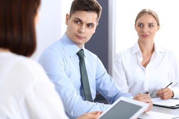 Obraz premium Group of business people or lawyers discussing terms of transaction in office. Meeting and teamwork concept