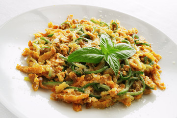zucchini spaghetti carbonara decorated with basil leafs