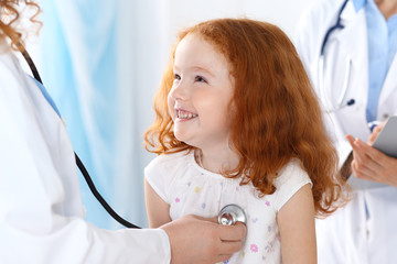 Doctor examining a little girl with stethoscope.Medicine and healthcare concept