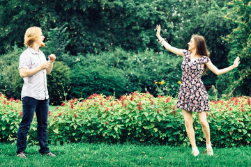 Couple blowing bubbles outdoor