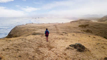 Fototapeta premium Young woman walking on Merese hill