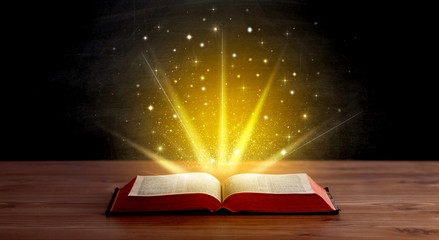 Yellow lights and sparkles coming from an open book 