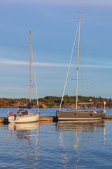 Picturesque yachts in Risor harbor in the Norwegian Riviera in evening light, Southern Norway