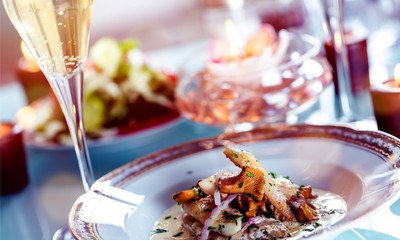 Close-up of Table with Food, Plates, Candles and Champagne
