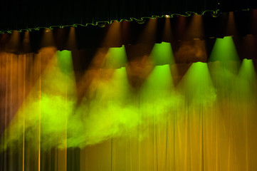 Stage background with lights. Soft focus. Illuminated concert stage without people, with green, yellow, orange light and stage fog. Light effect. Nobody.