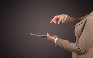 Female hand in suit holding tablet with no wallpaper
