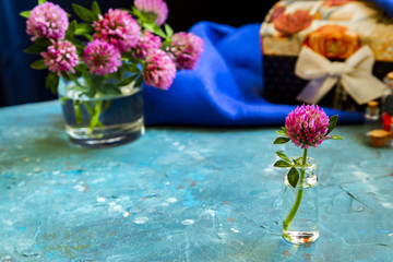 Pink Clover flowers on table with blue background