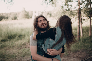 Young laughing hugging adult pair. Man and woman.