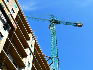 Skyscraper construction.Tower crane near concrete building under constriction. Construction site.