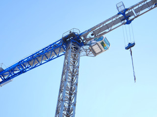 Construction crane against blue sky.Construction site.