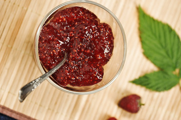 raspberry jam on bamboo background