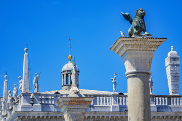 Fototapeta na wymiar Lion of Venice at Ancient column (1268), bronze winged lion sculpture in the Piazza San Marco - the symbol of Venice city. Venice, Italy. Venice - UNESCO world heritage Site.