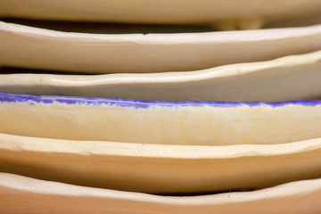 plates of clay ceramics stacked in a stack