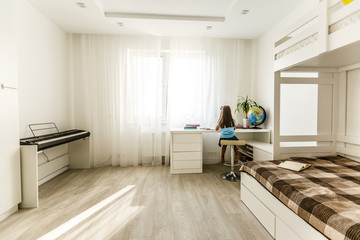 Little girl calculator and set of plastic globe in living room