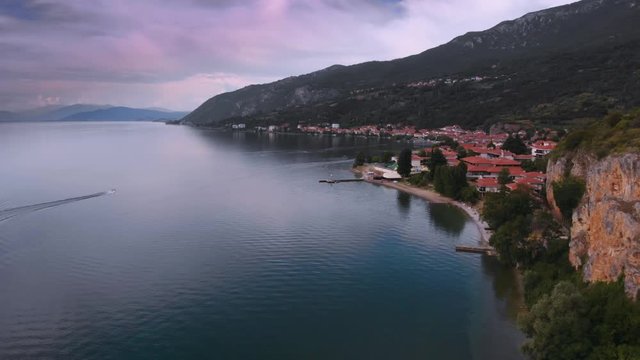 Aerial (drone) dolly backward shot of Macedonian shore in Ohrid Lake, Pesztani and Trpejca