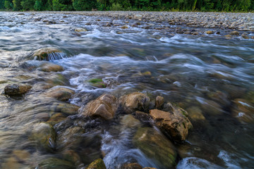 Rapid flow of a mountain river, clear water