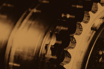 Monochrome background image of gear close up. Artwork from auto part in macro photography. Sepia...
