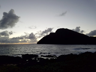Ocean waves lap on Makapuu beach before dawn