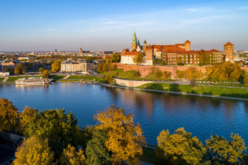 Obraz premium Panorama of Cracow, Poland, with royal Wawel castle, cathedral and Vistula river in autumn. Aerial view at sunset.