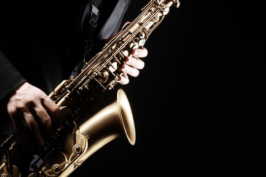 Saxophone player. Saxophonist playing jazz music instrument
