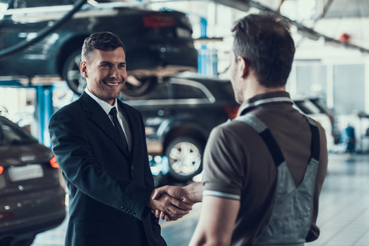 Handshake between Auto Mechanic and Client in Suit