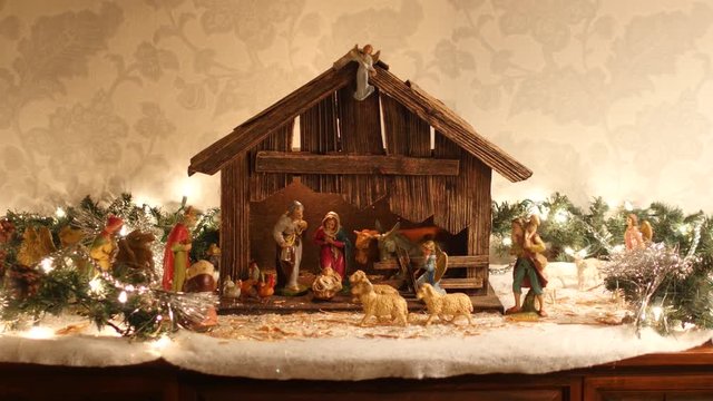 Static shot of a vintage old Christmas nativity or manger scene from Europe, featuring animals, the magi, shepherds, angels and the holy family (Mary, Joseph and baby Jesus).