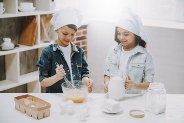 Portrait of Girl and Boy Cooking at Kitchen