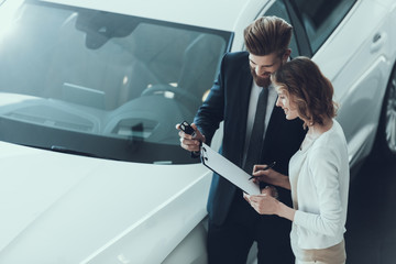 Car Salesman Consultant Showing Contract to Woman