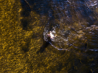 top overhead viea of young man enjoying sea water on the beach, standing on summer day