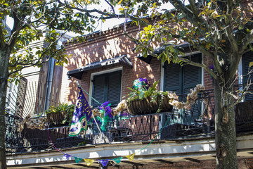 Traditional Brick Colonial Home with a Mardi Gras Flag and Decorations on the Balcony in the French...